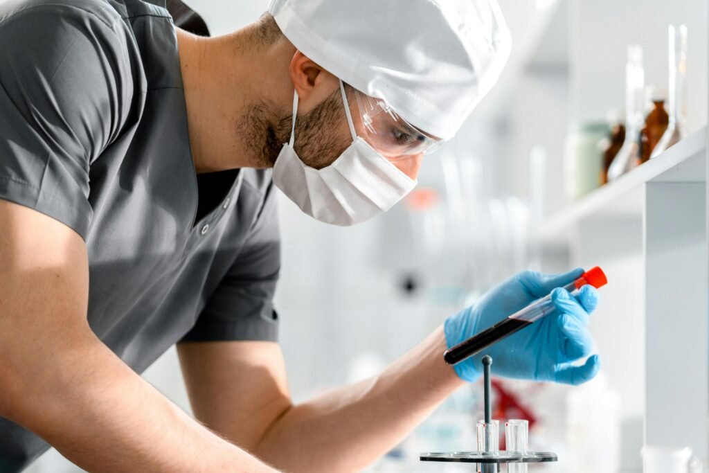 pexels photo 9629682 9629682 A researcher in a lab coat carefully examines a test tube, symbolizing scientific discovery and research.